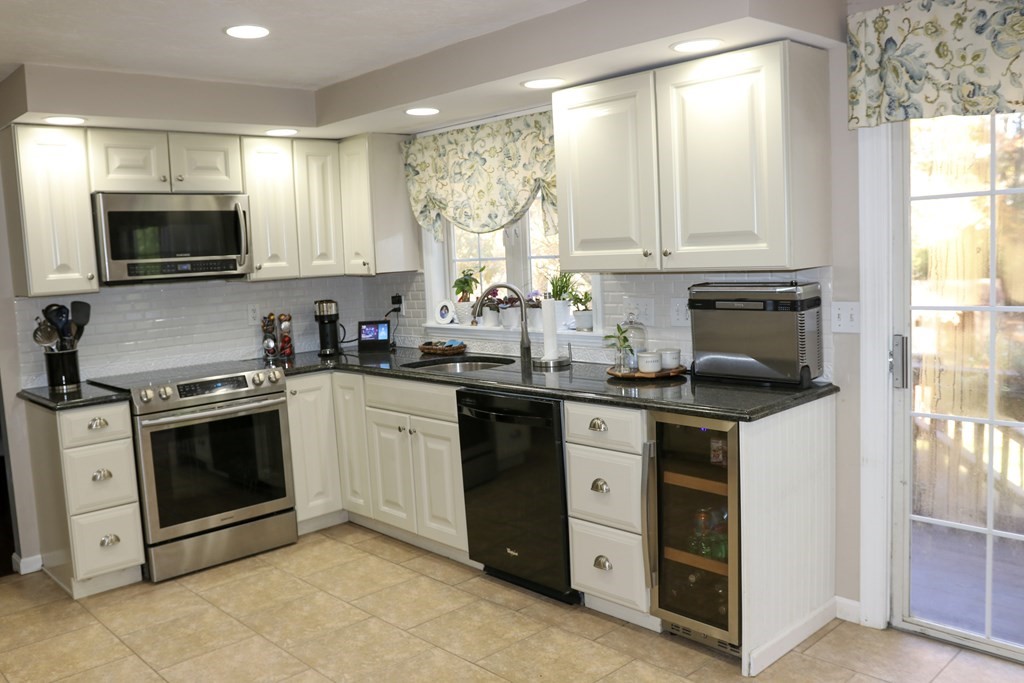 28 South Meadow Road Clinton, MA 01510 - Photo 7 of 24 a kitchen with stainless steel appliances granite countertop a stove a sink and a microwave