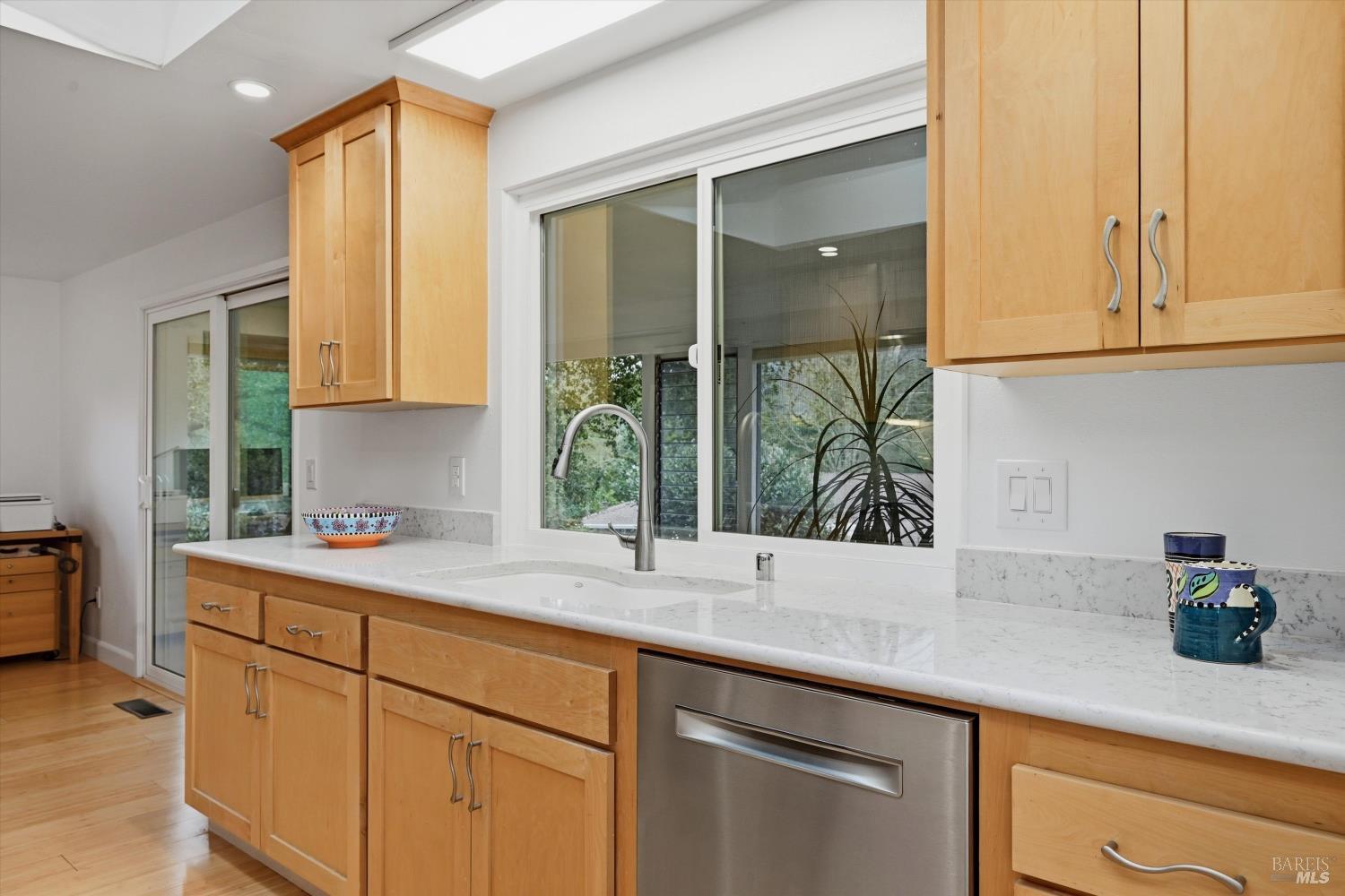 6480 Meadowridge Drive Santa Rosa, CA 95409 - Photo 11 of 26 a kitchen with stainless steel appliances white cabinets and a window