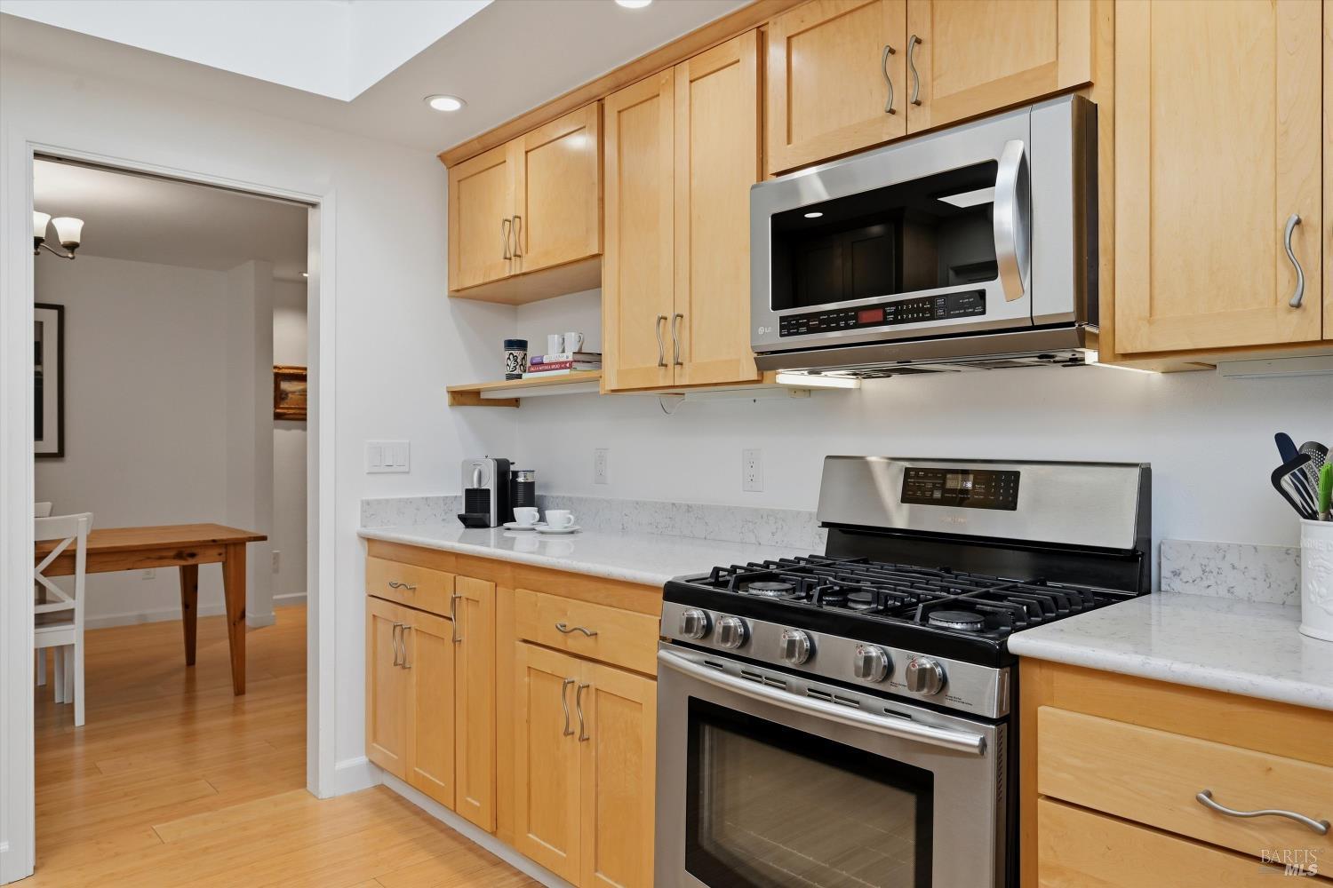 6480 Meadowridge Drive Santa Rosa, CA 95409 - Photo 12 of 26 a kitchen with stainless steel appliances granite countertop white cabinets and a stove top oven