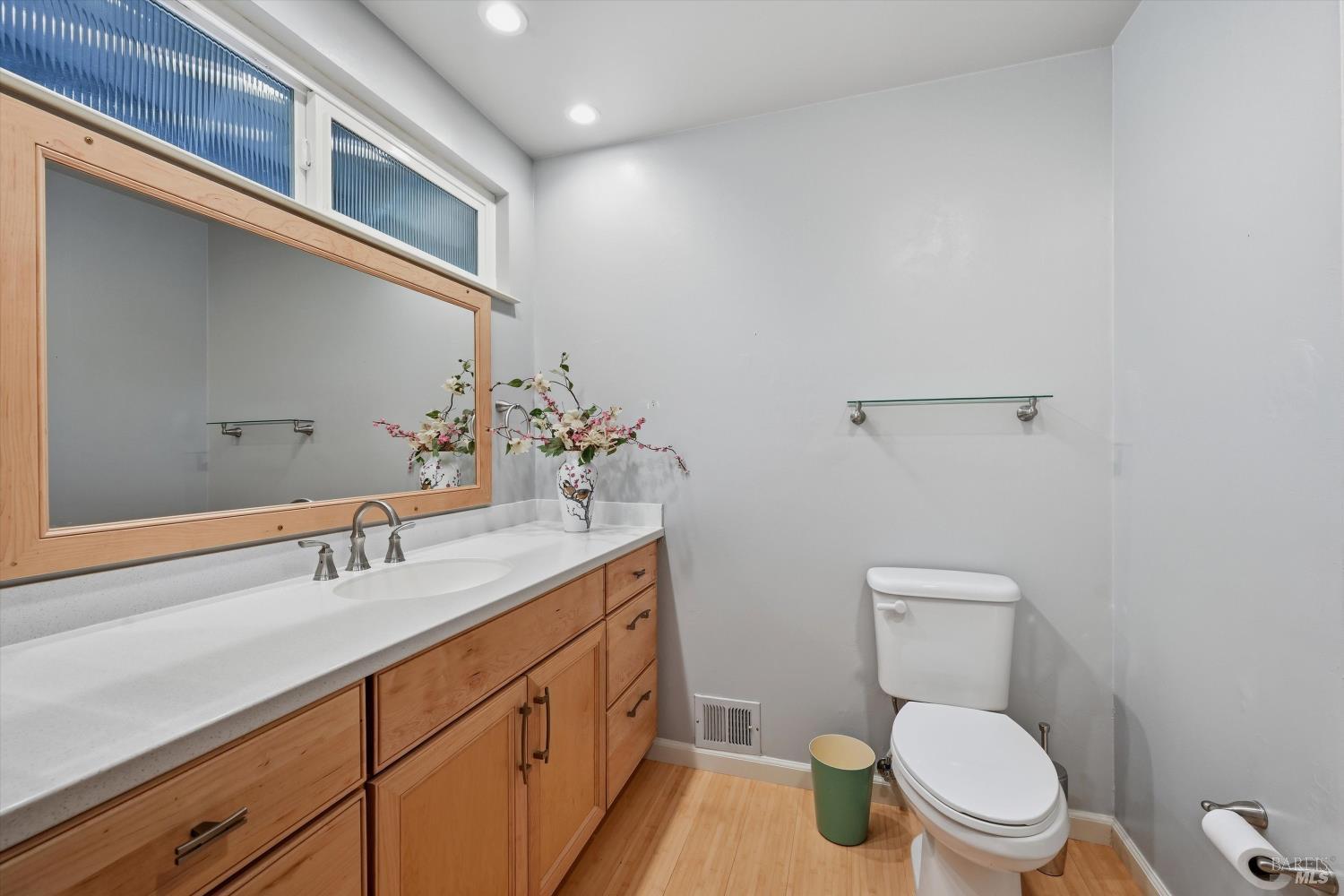 6480 Meadowridge Drive Santa Rosa, CA 95409 - Photo 17 of 26 a bathroom with a toilet a sink and mirror