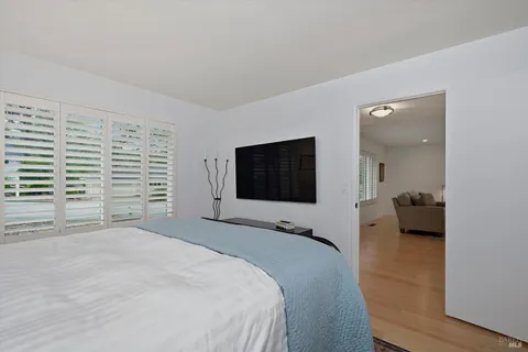 a bedroom with a bed and a flat screen tv