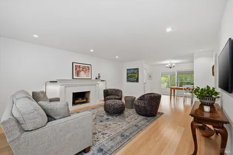 a living room with furniture flat screen tv and a fireplace