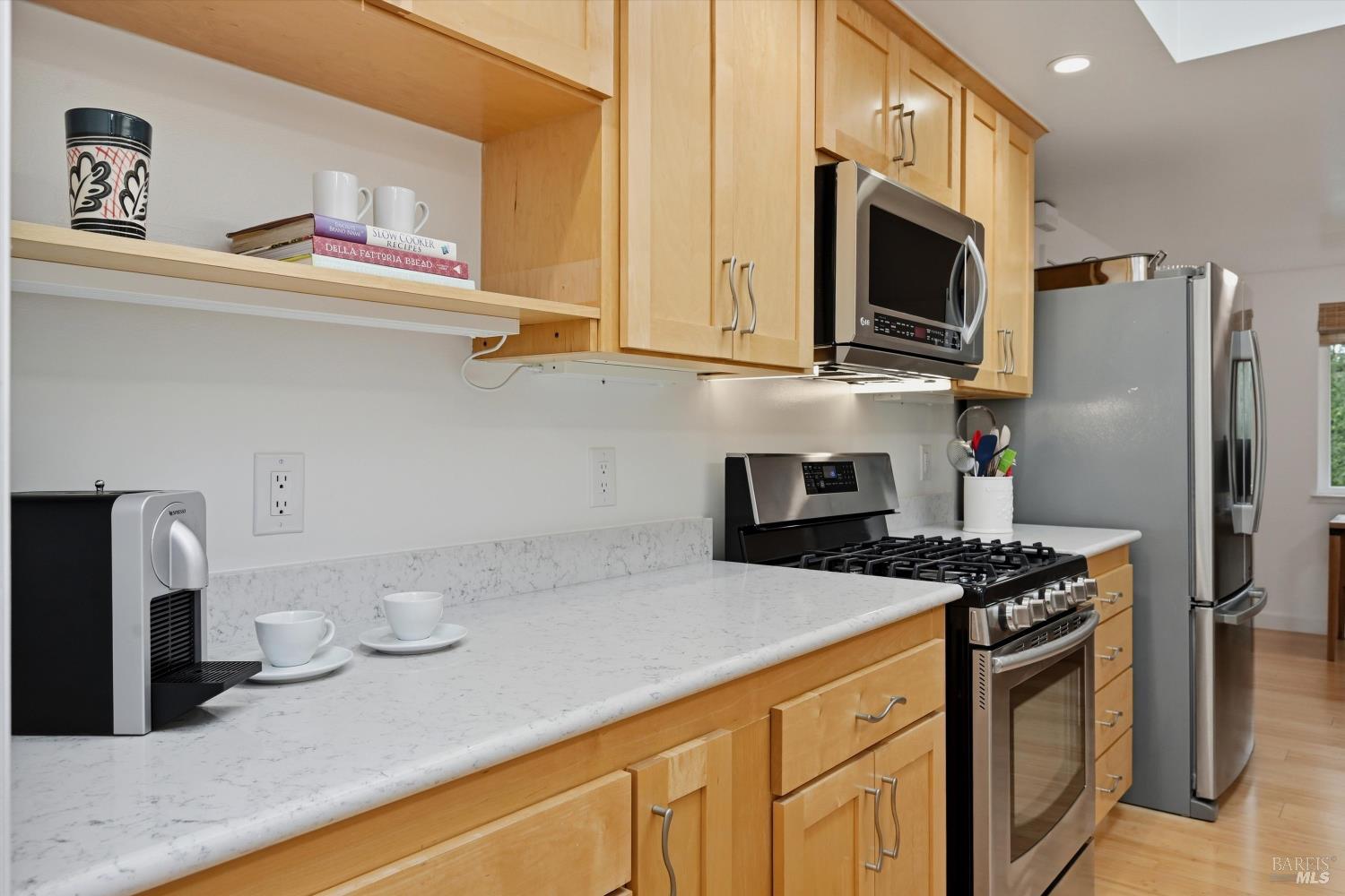 6480 Meadowridge Drive Santa Rosa, CA 95409 - Photo 10 of 26 a kitchen with stainless steel appliances granite countertop a sink a stove a microwave and wooden cabinets