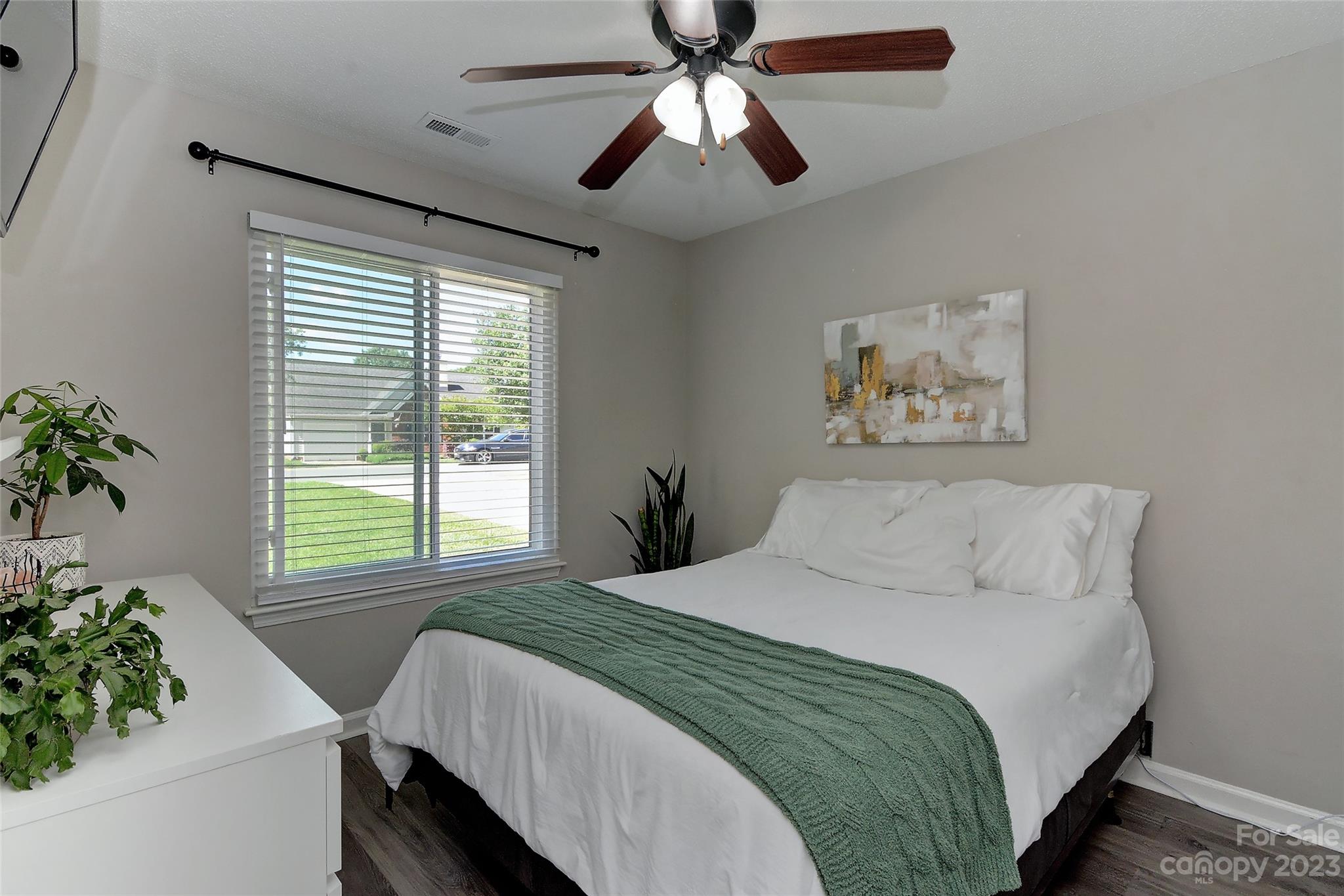 1016 Ridgefield Circle Indian Trail, NC 28079 - Photo 13 of 19 a bedroom with a large bed and a chandelier