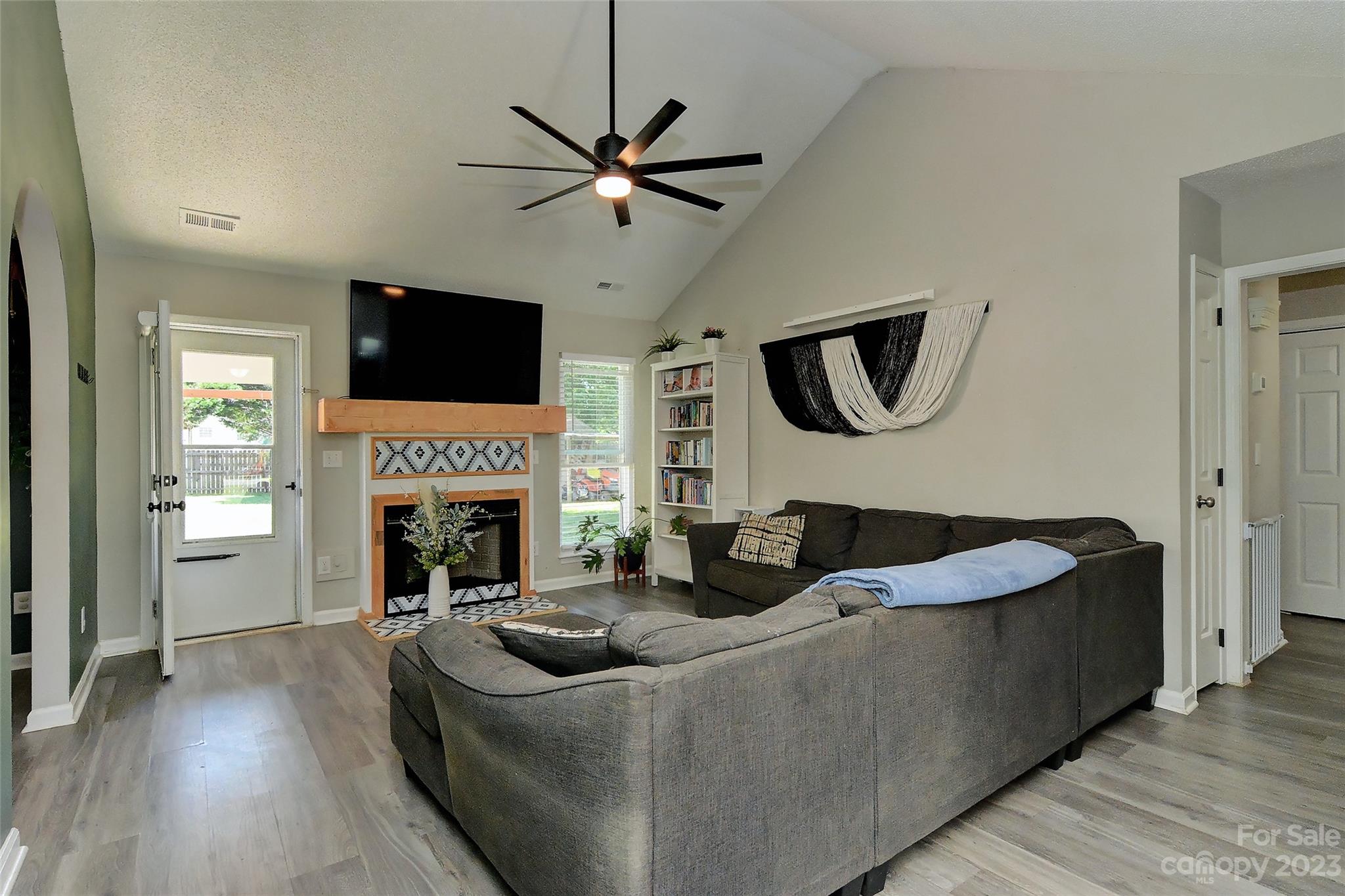 1016 Ridgefield Circle Indian Trail, NC 28079 - Photo 2 of 19 a living room with furniture a fireplace and a flat screen tv