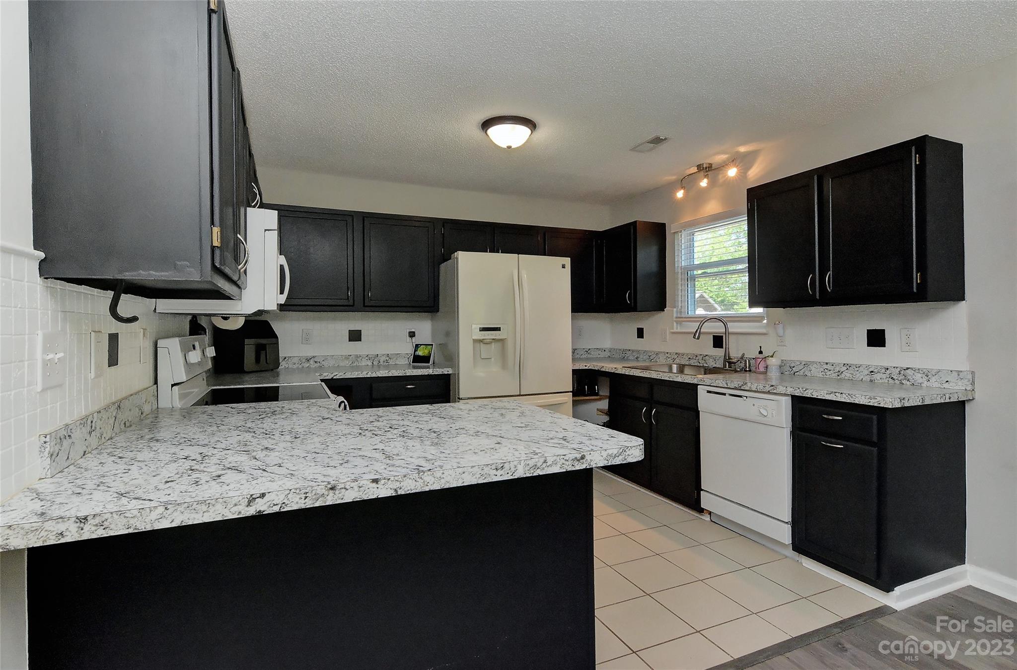 1016 Ridgefield Circle Indian Trail, NC 28079 - Photo 3 of 19 a kitchen with stainless steel appliances granite countertop a sink stove and refrigerator