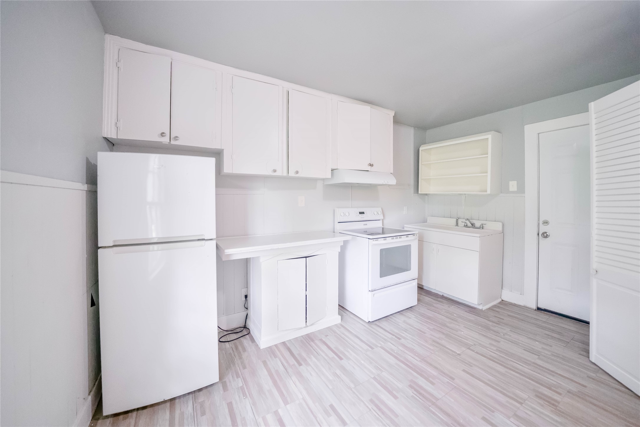 5101 Crane Street, Unit 2 Houston, TX 77026 - Photo 2 of 6 a kitchen with white cabinets and white appliances