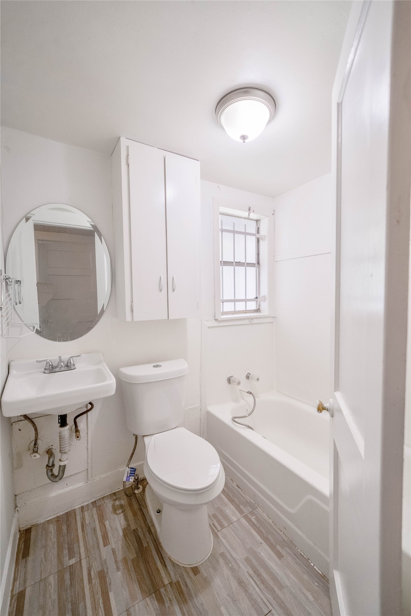 5101 Crane Street, Unit 2 Houston, TX 77026 - Photo 4 of 6 a bathroom with a sink toilet a mirror and bathtub
