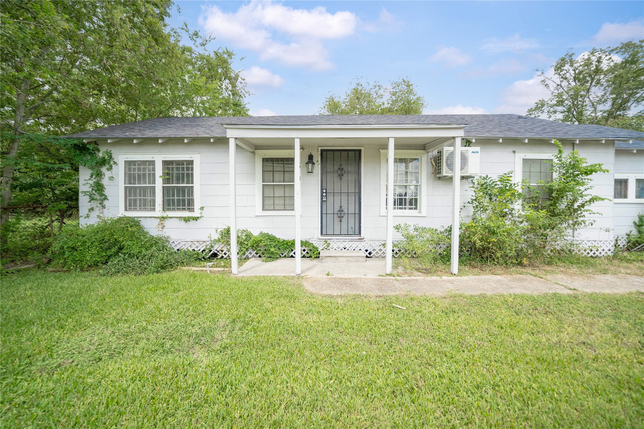 5101 Crane Street, Unit 2 Houston, TX 77026 - Photo 5 of 6 front view of a house with a yard and potted plants
