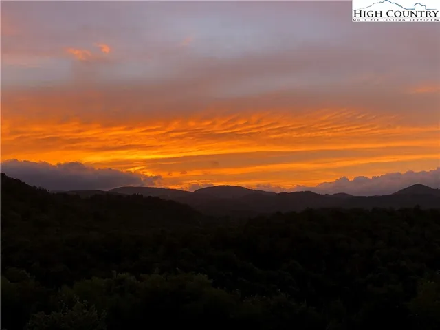 a room with furniture and floor to ceiling windows