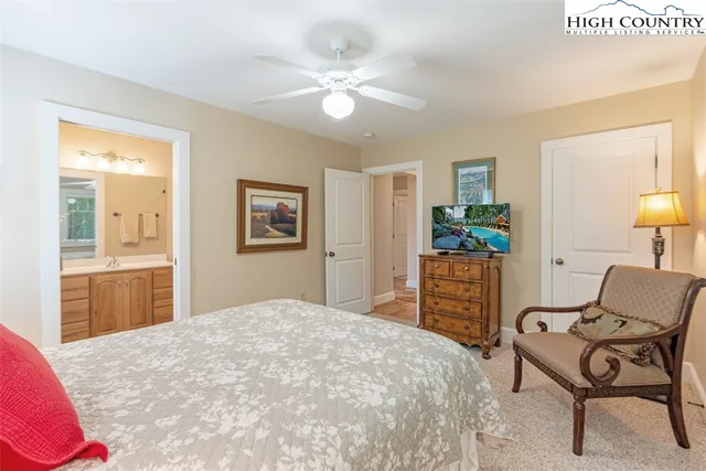 a bedroom with a bed and a tv on the dresser