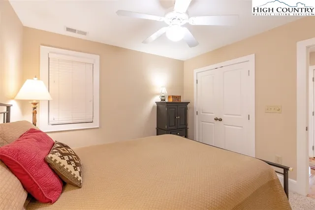 a bathroom with a toilet and a shower curtain