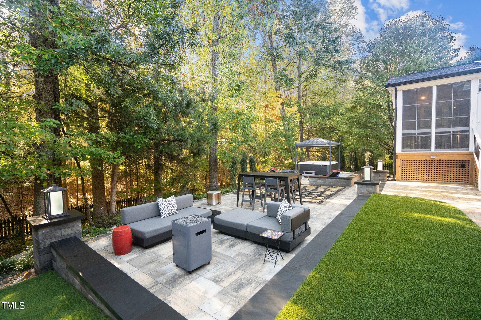 8818 Fidelis Lane Raleigh, NC 27613 - Photo 8 of 78 a view of a patio with couches and a table and chairs with garden view