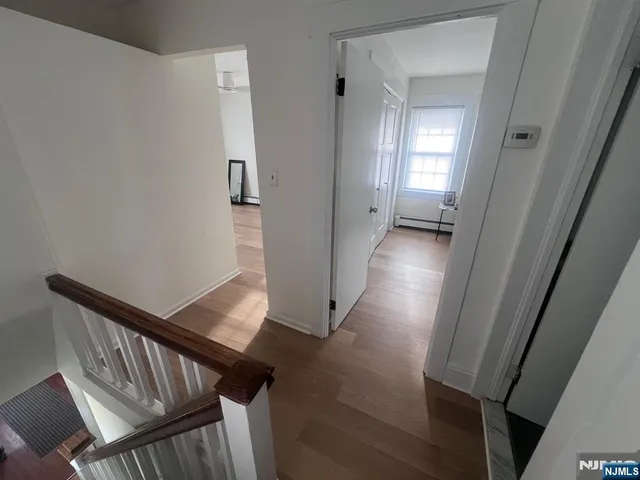 a view of a hallway and wooden floor