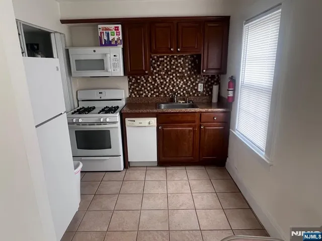 a kitchen with stainless steel appliances a stove and a refrigerator