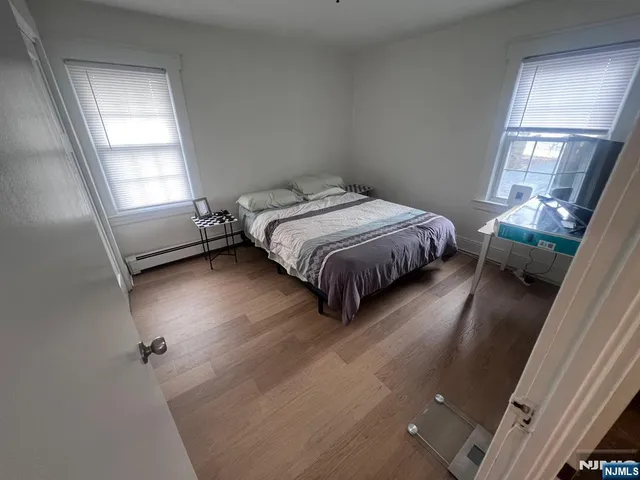 a bathroom with a bathtub a sink a toilet a baby and a window