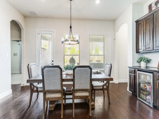 a kitchen with stainless steel appliances granite countertop a sink a stove and a wooden floors