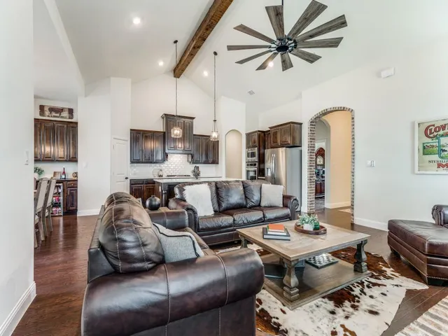 a view of a living room kitchen and a wooden floor