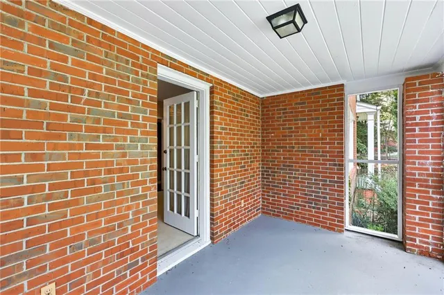 a open kitchen with a table chairs and a refrigerator