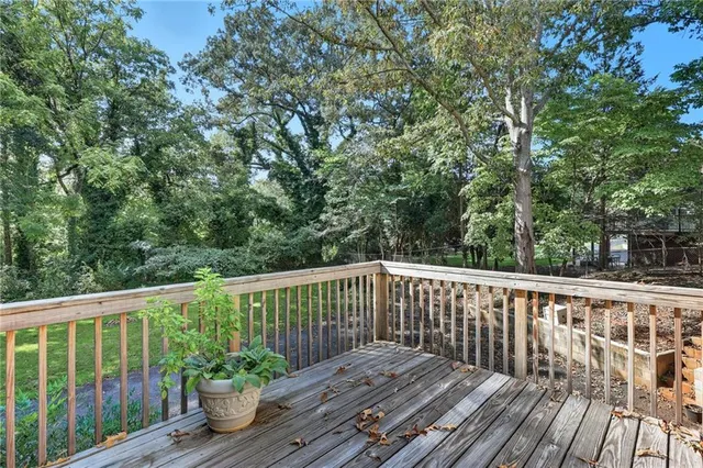 a kitchen with stainless steel appliances granite countertop a stove a refrigerator a kitchen island a dining table and chairs with wooden floor