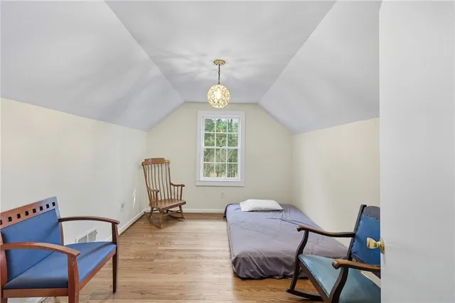 a view of a room with chairs and wooden floor