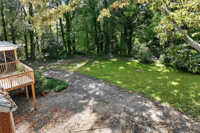 a house with green field in front of it