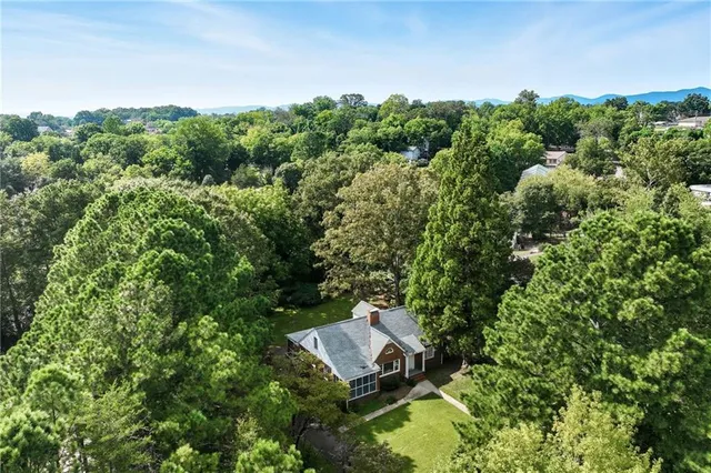 an aerial view of residential house with outdoor space and trees