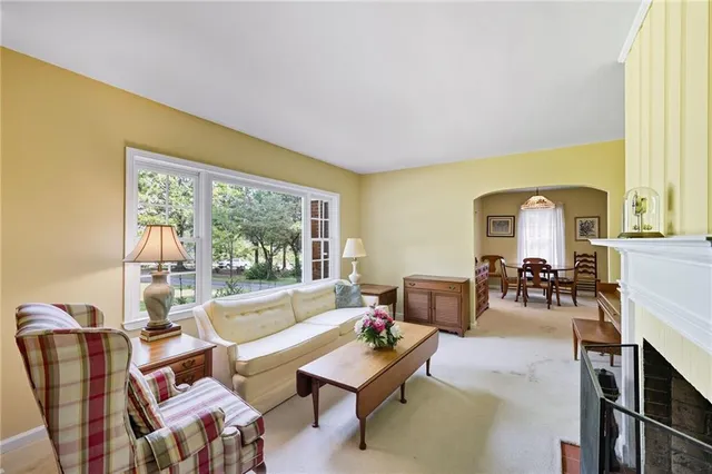 a living room with furniture and flowers