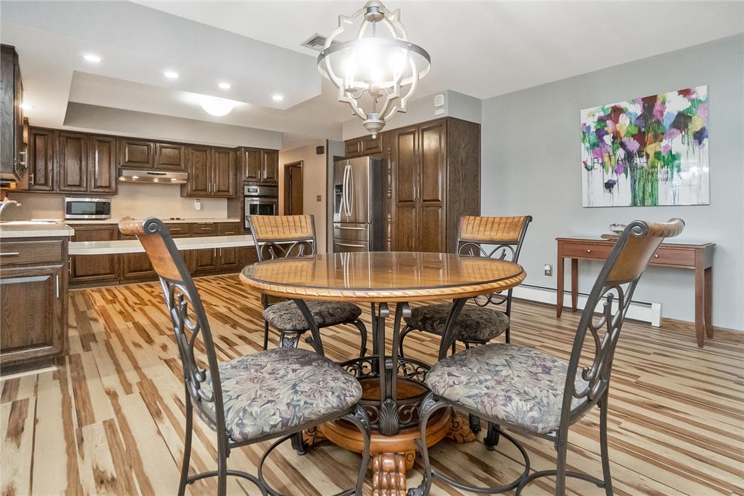 5728 Pheasant Road Bethlehem, PA 18017 - Photo 12 of 39 Striking floors anchor the open-concept layout connecting the dining space to the kitchen.