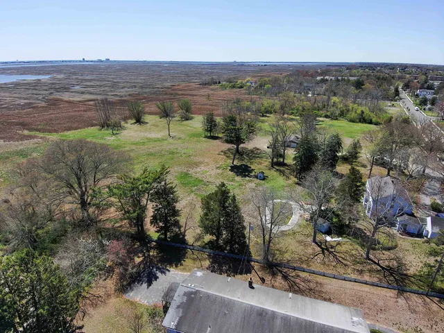 an aerial view of a houses with a yard