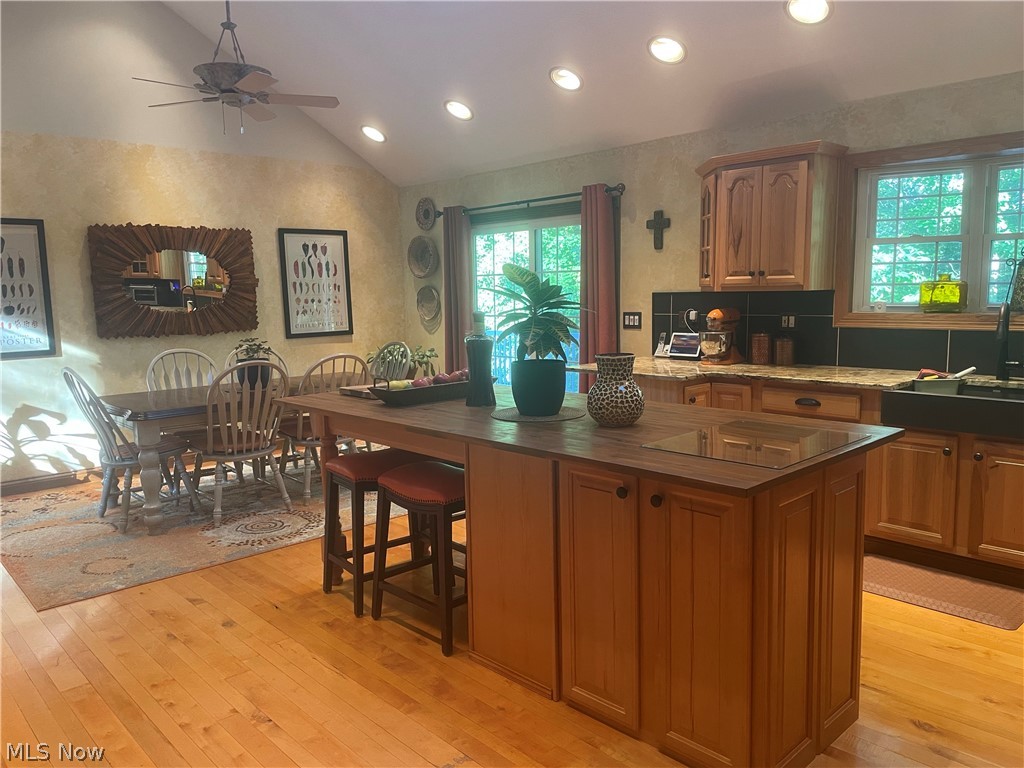 2002 Laurel Ridge Road Culloden, WV 25510 - Photo 11 of 36 Kitchen featuring ceiling fan, a center island, a breakfast bar, hardwood flooring, and lofted ceiling