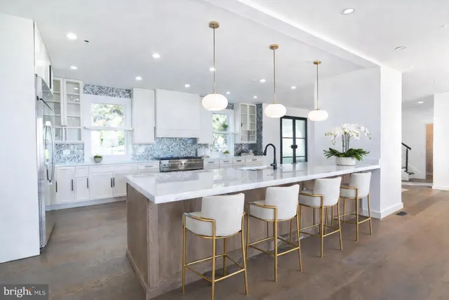 a large kitchen with a table and chairs