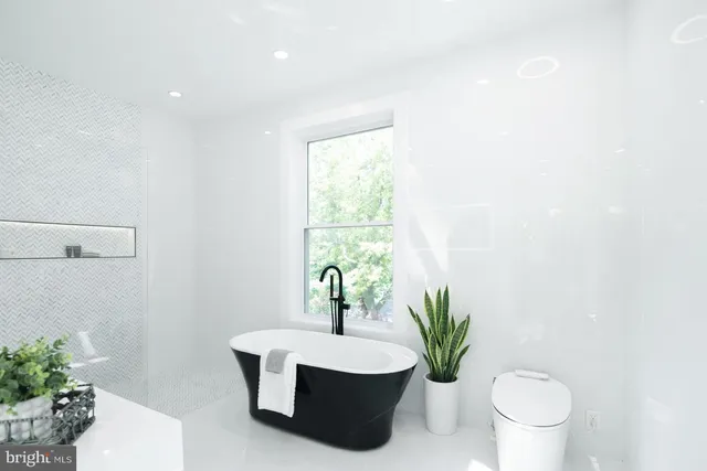 a white bath tub sitting next to a white toilet