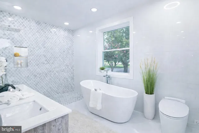 a bathroom with a sink a toilet and a bathtub