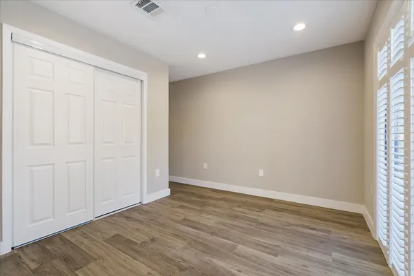 a view of kitchen with refrigerator and wooden floor