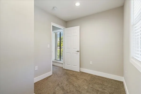a bedroom with a large bed and closet