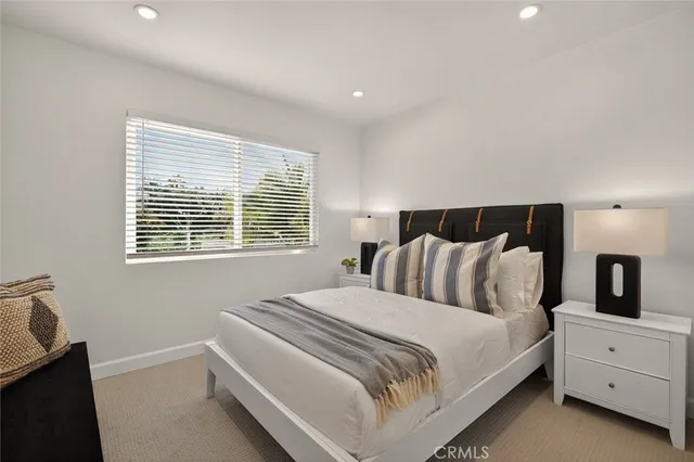 a bed room with a bed and a window