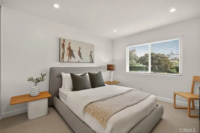 a bedroom with bed and window