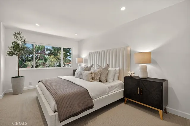 a bedroom with a large bed and a window