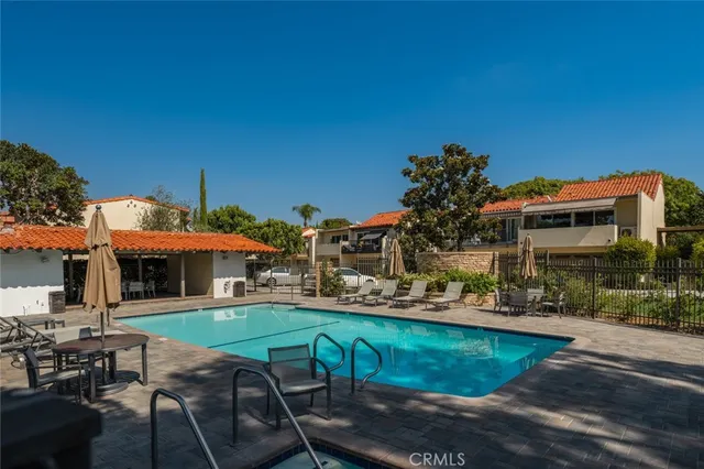 a view of a patio with table and chairs under an umbrella