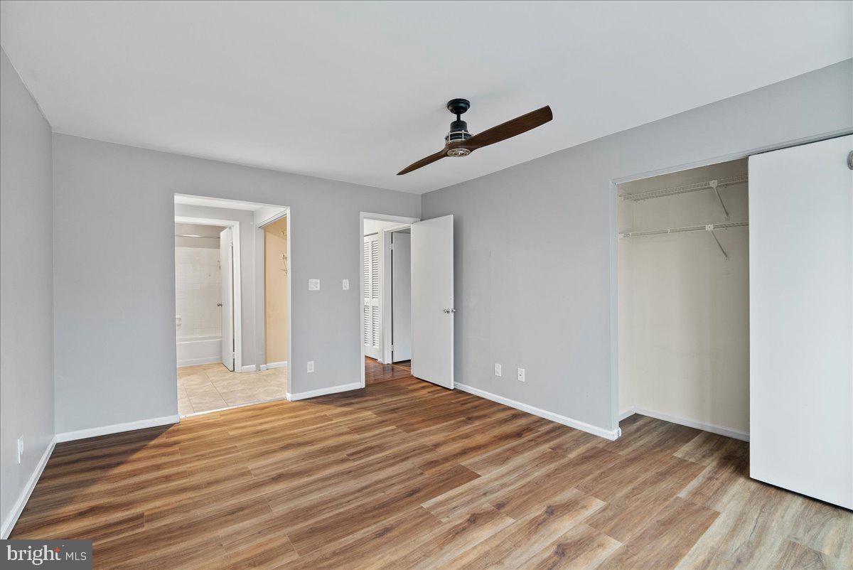 11146 Beaver Trail Court Reston, VA 20191 - Photo 13 of 17 a view of empty room with wooden floor and ceiling fan