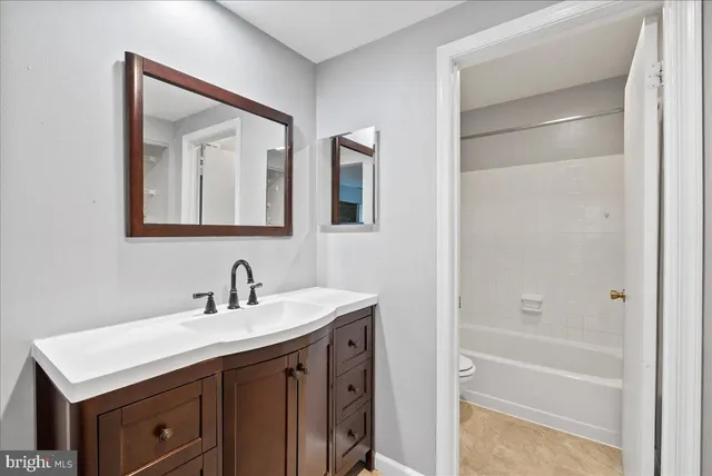 a bathroom with a sink a vanity and a mirror