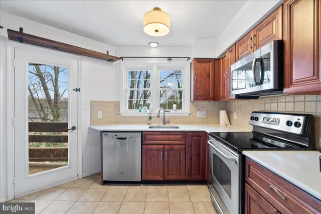 a kitchen with a sink stove and cabinets