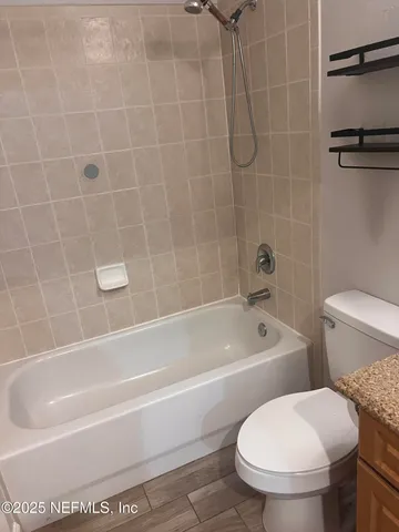 a bathroom with toilet sink and a shower