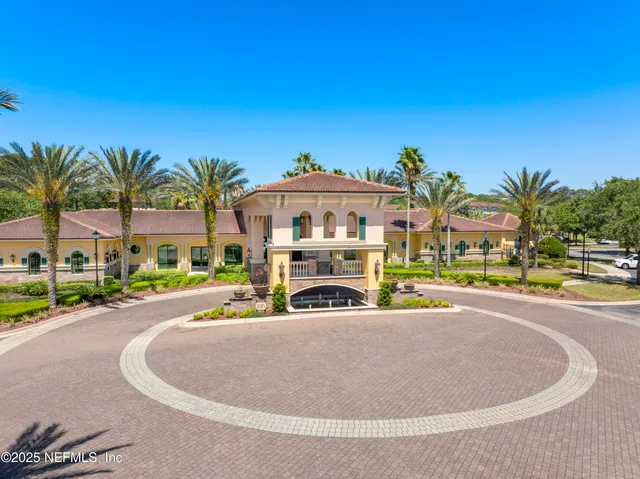 a view of water with boats and palm trees