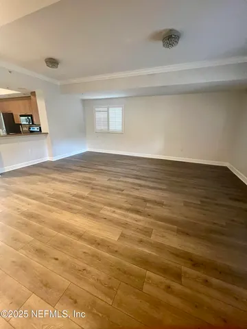 a view of a room with wooden floor