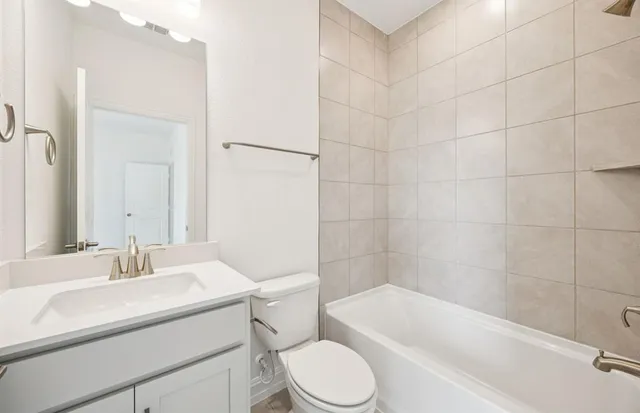 a bathroom with a sink a toilet and bathtub