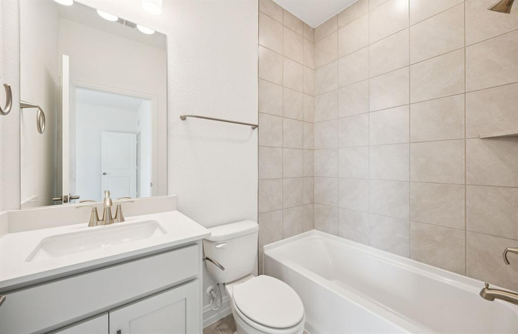 3048 Cliffside Drive Celina, TX 75009 - Photo 13 of 14 a bathroom with a sink a toilet and bathtub