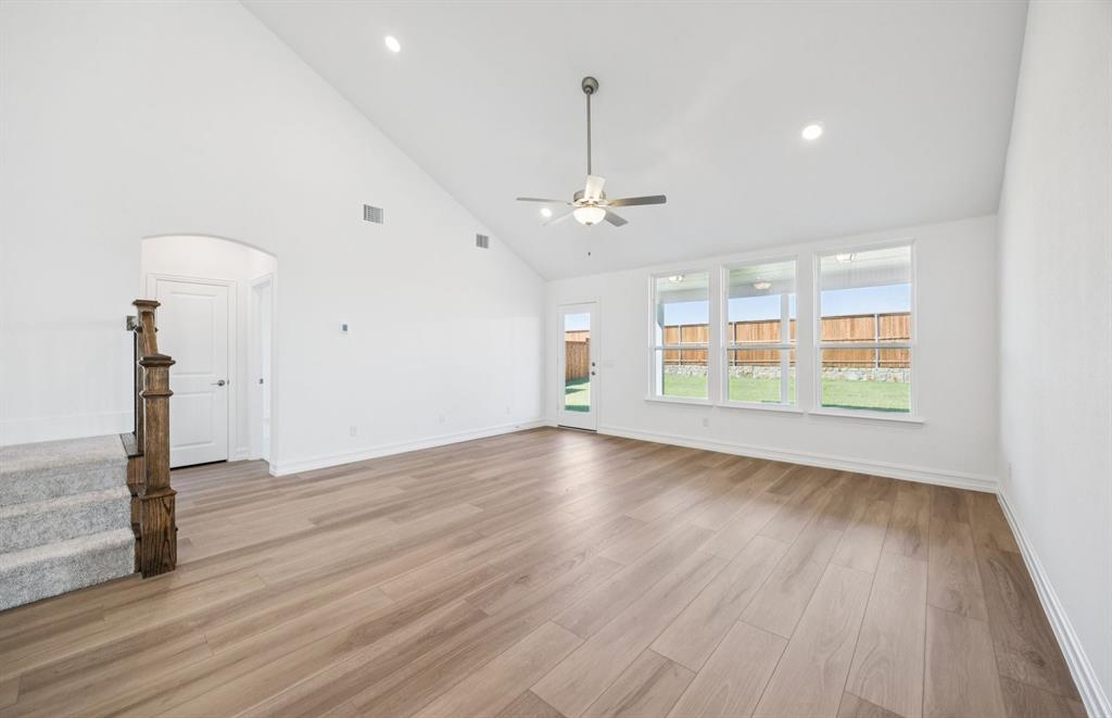 3048 Cliffside Drive Celina, TX 75009 - Photo 5 of 14 a view of an empty room with wooden floor and a window