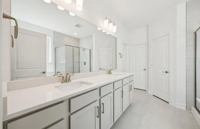 a bathroom with a double vanity sink mirror and